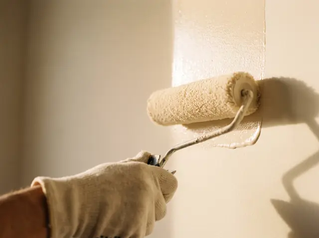 Paint roller applying a smooth coat